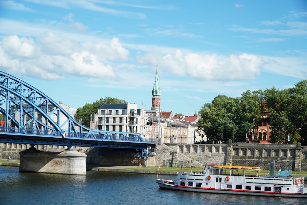 a boat on a river with a bridge in the background