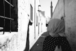 a woman in a hijab walking down a street