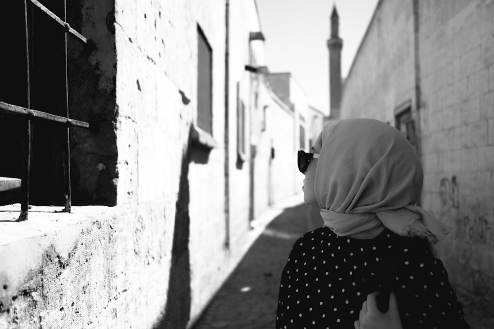 a woman in a hijab walking down a street