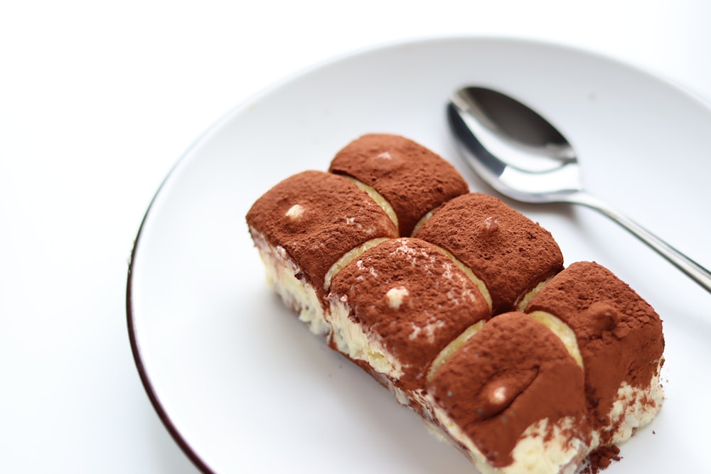 a piece of cake on a plate with a spoon