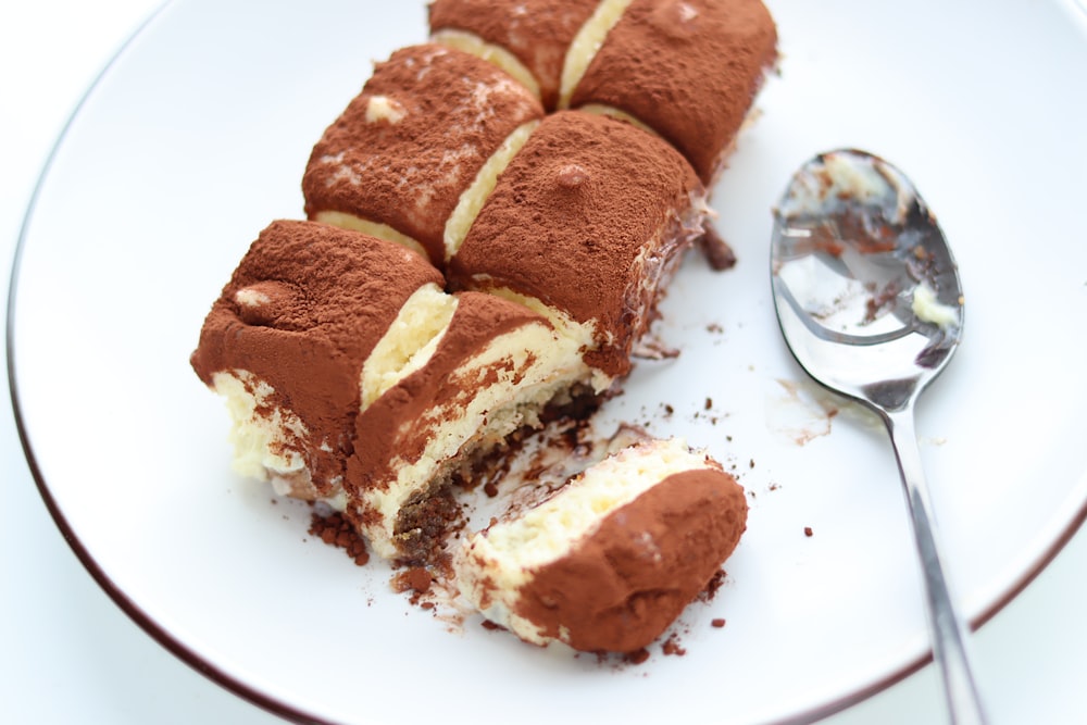 a piece of cake on a plate with a spoon