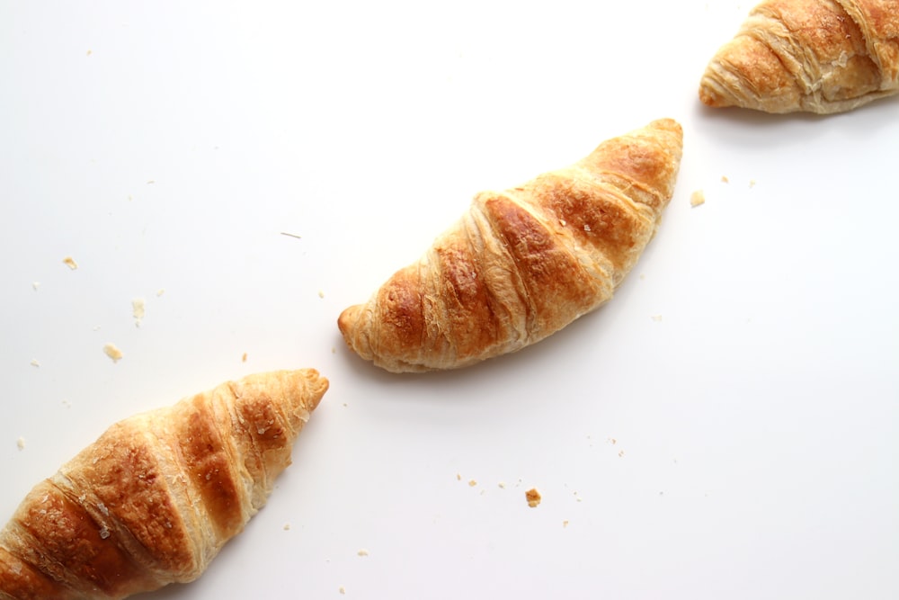 a couple of croissants sitting on top of a white counter