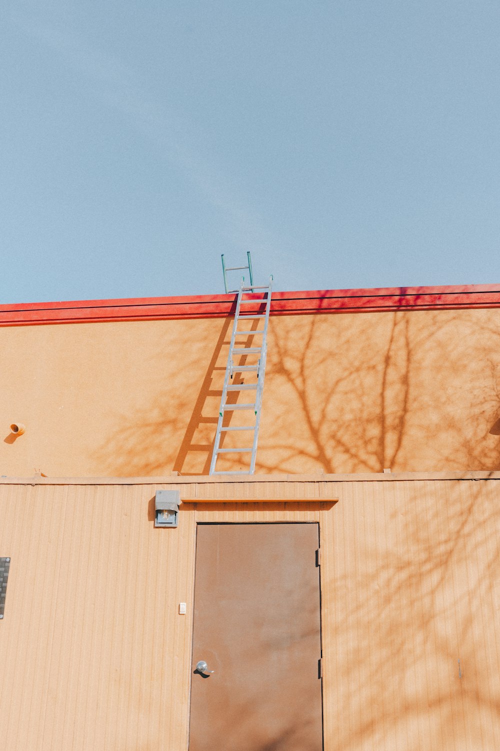 a ladder leaning up against a building next to a door