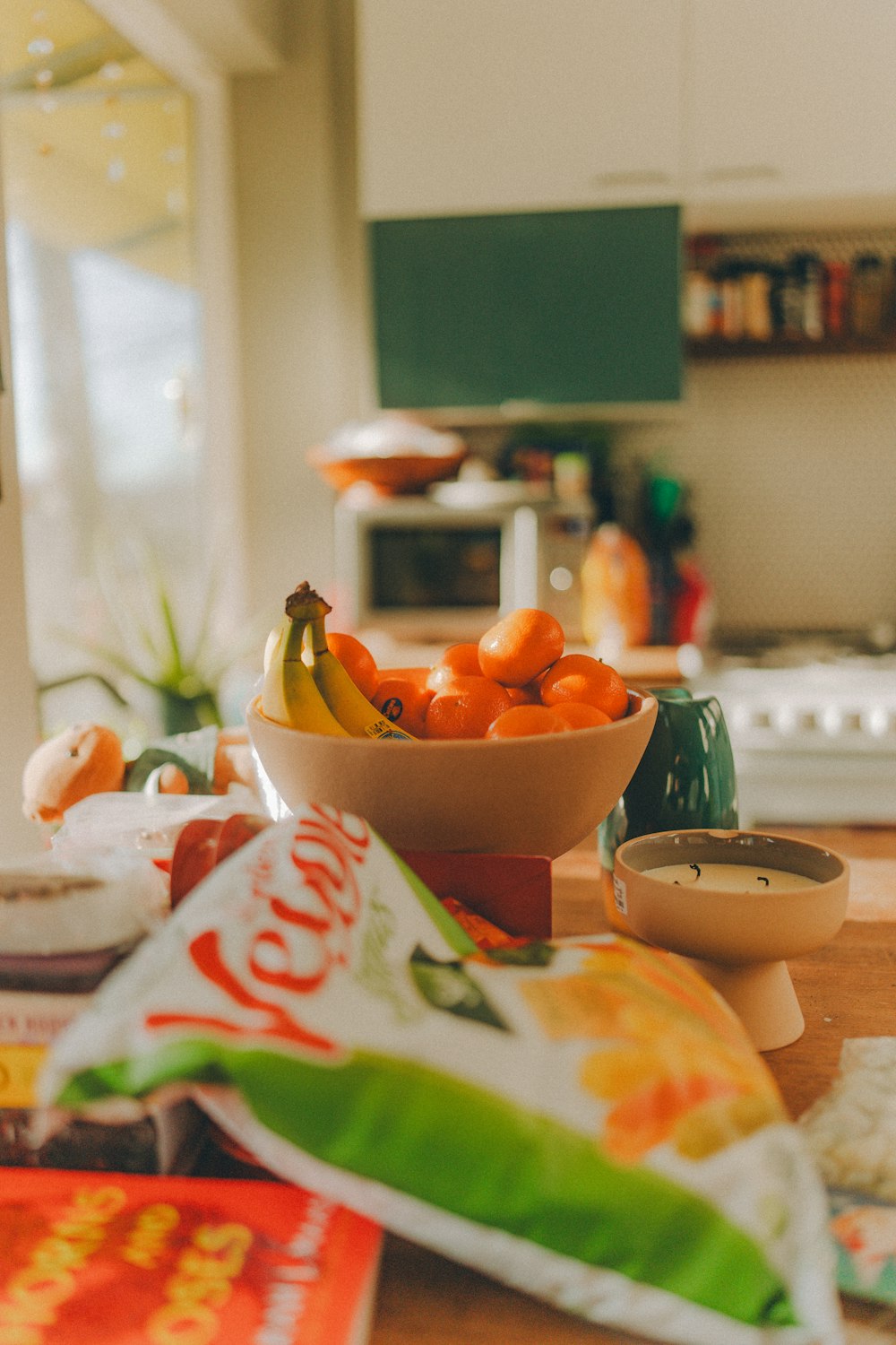 a bowl of fruit sitting on top of a table