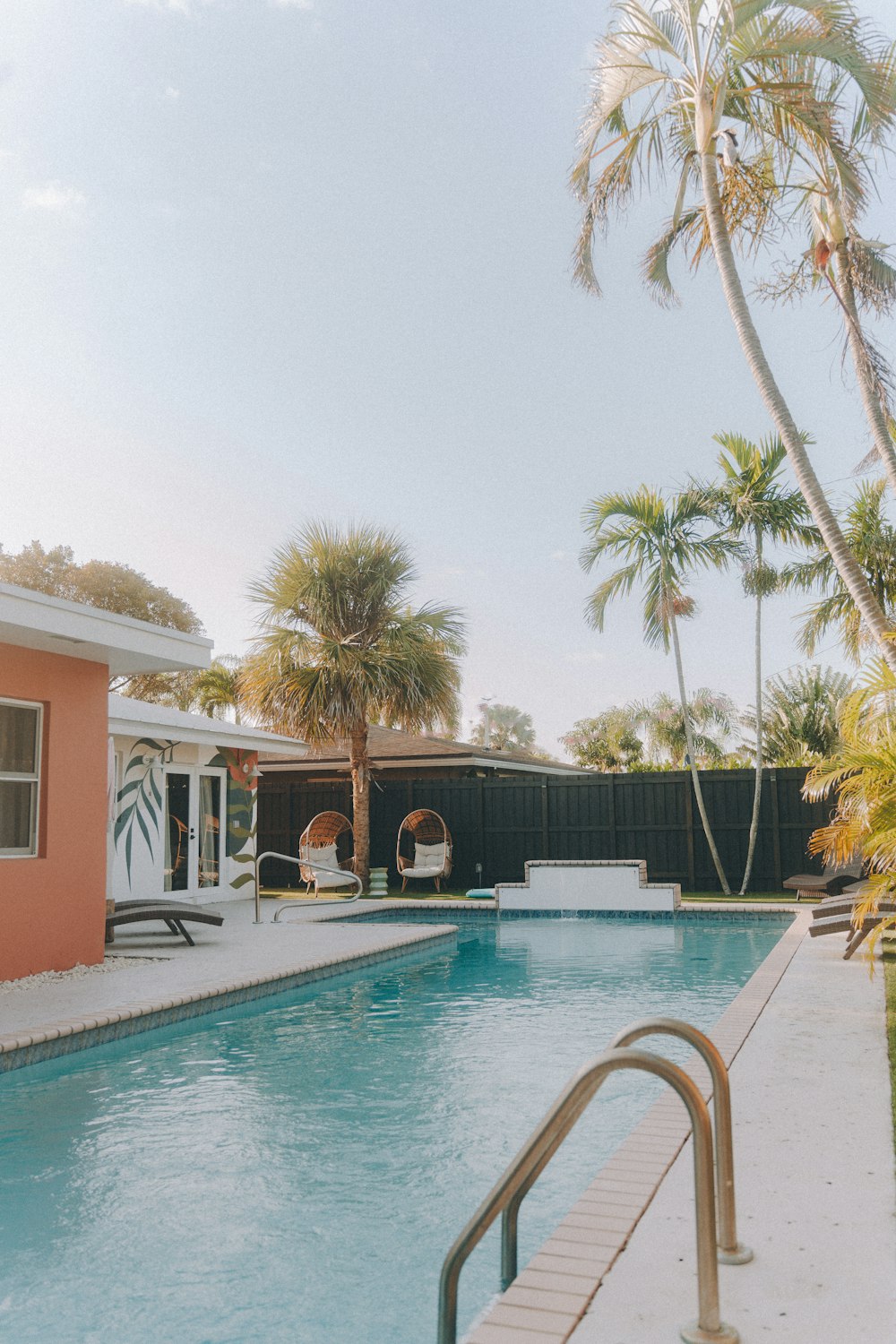 a swimming pool with a lounge chair next to it