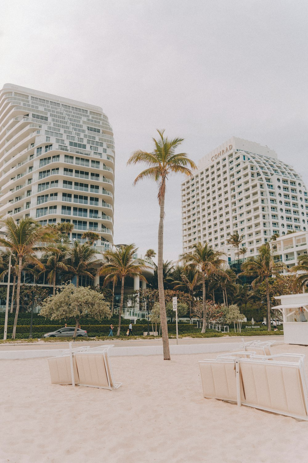 a row of beach chairs sitting on top of a sandy beach