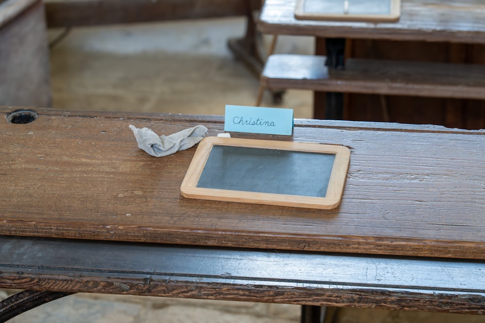 a wooden table topped with a tablet computer