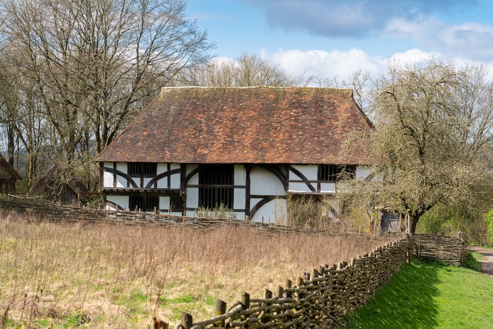 a white and black house with a brown roof