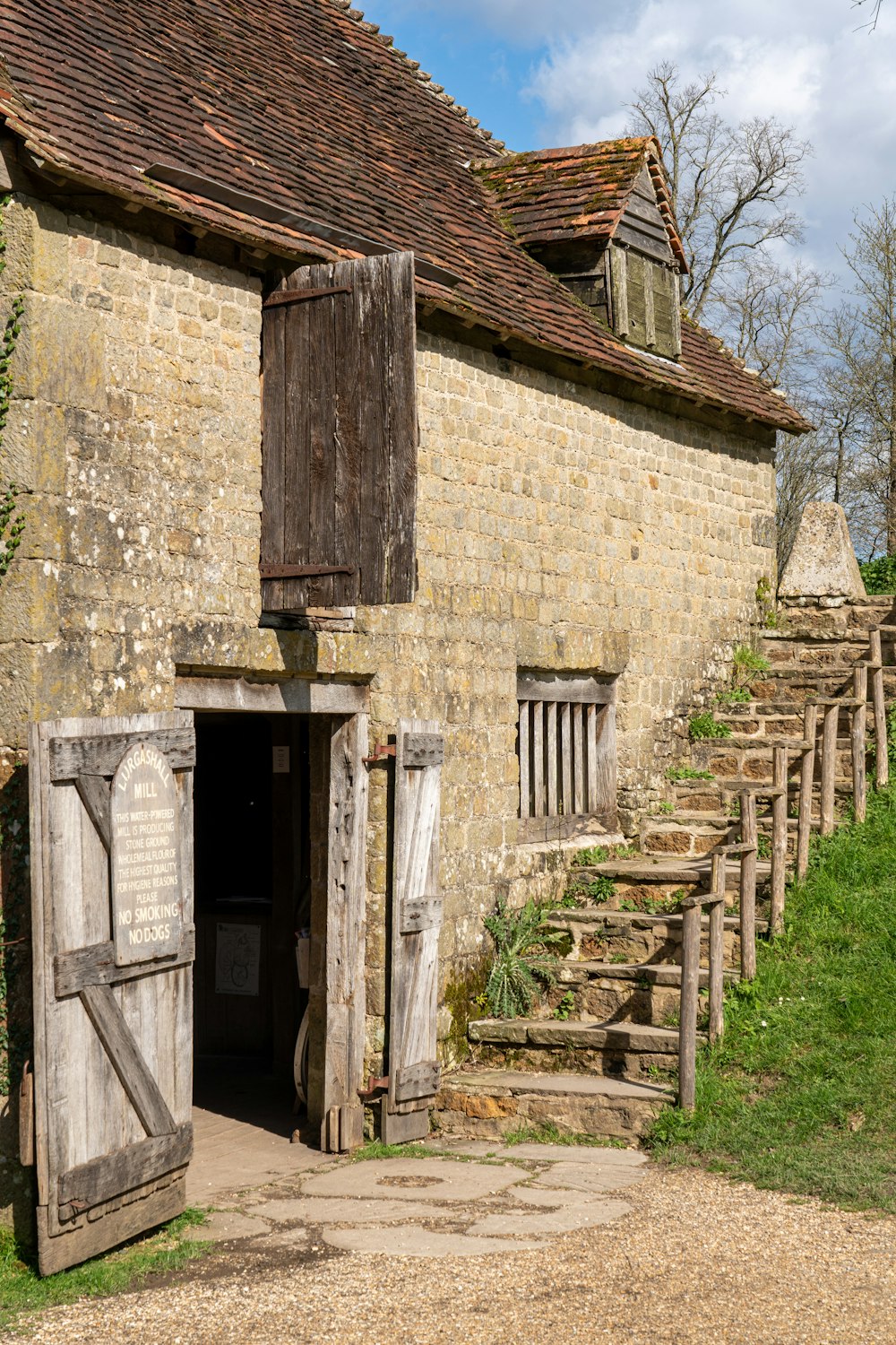 a stone building with a wooden door and window