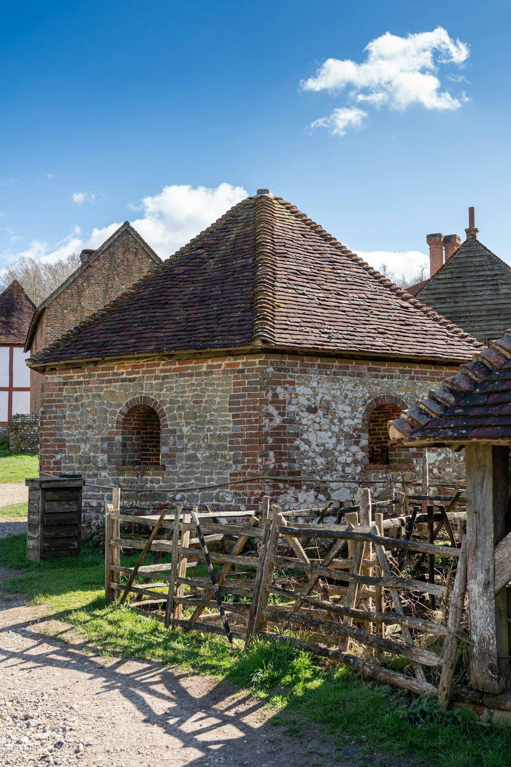 an old brick building with a wooden fence in front of it