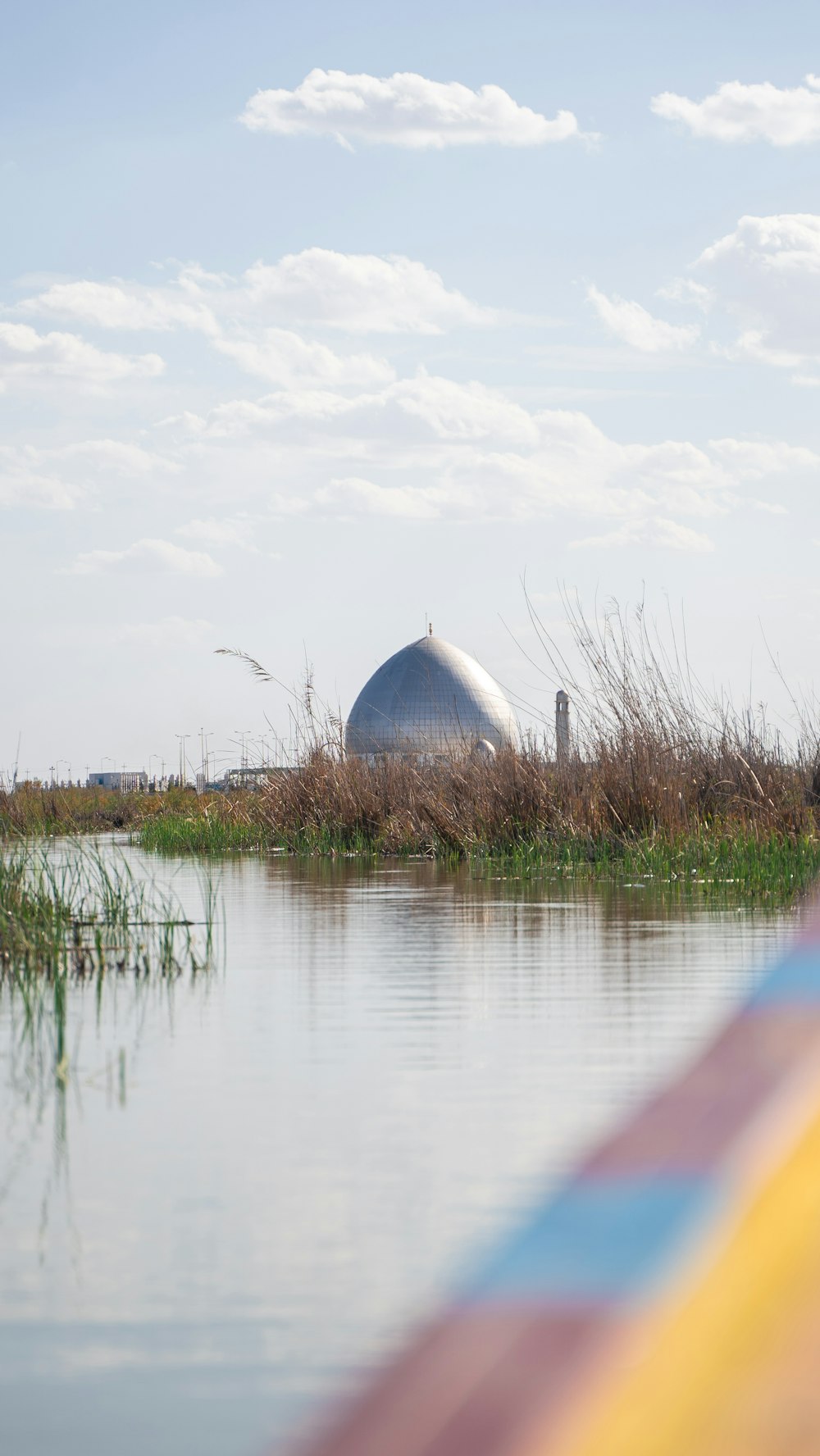 a view of a body of water with a building in the background