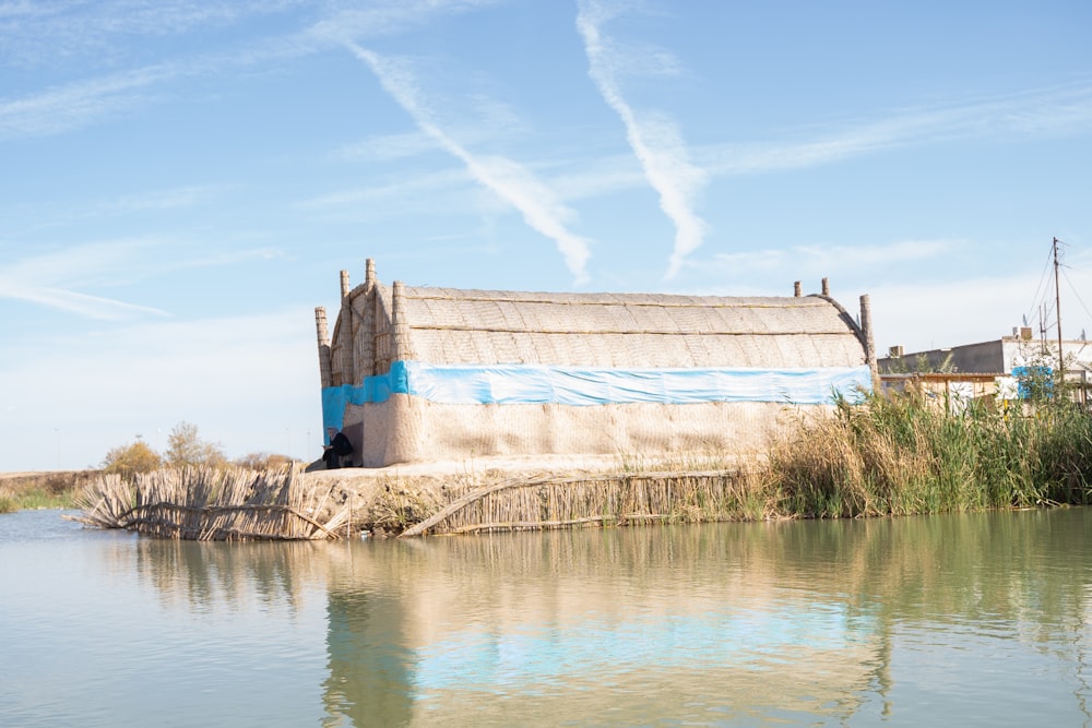 a building sitting on the edge of a body of water