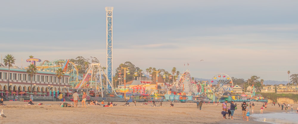 a group of people standing on top of a sandy beach