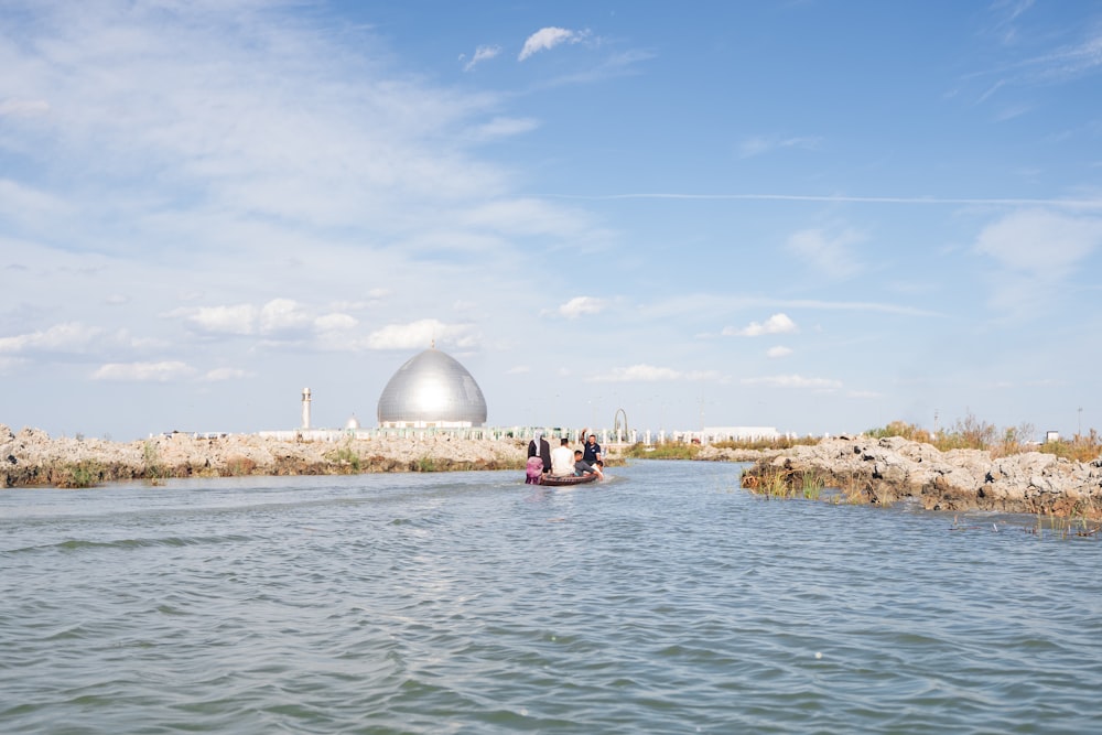 a couple of people in a small boat in the water