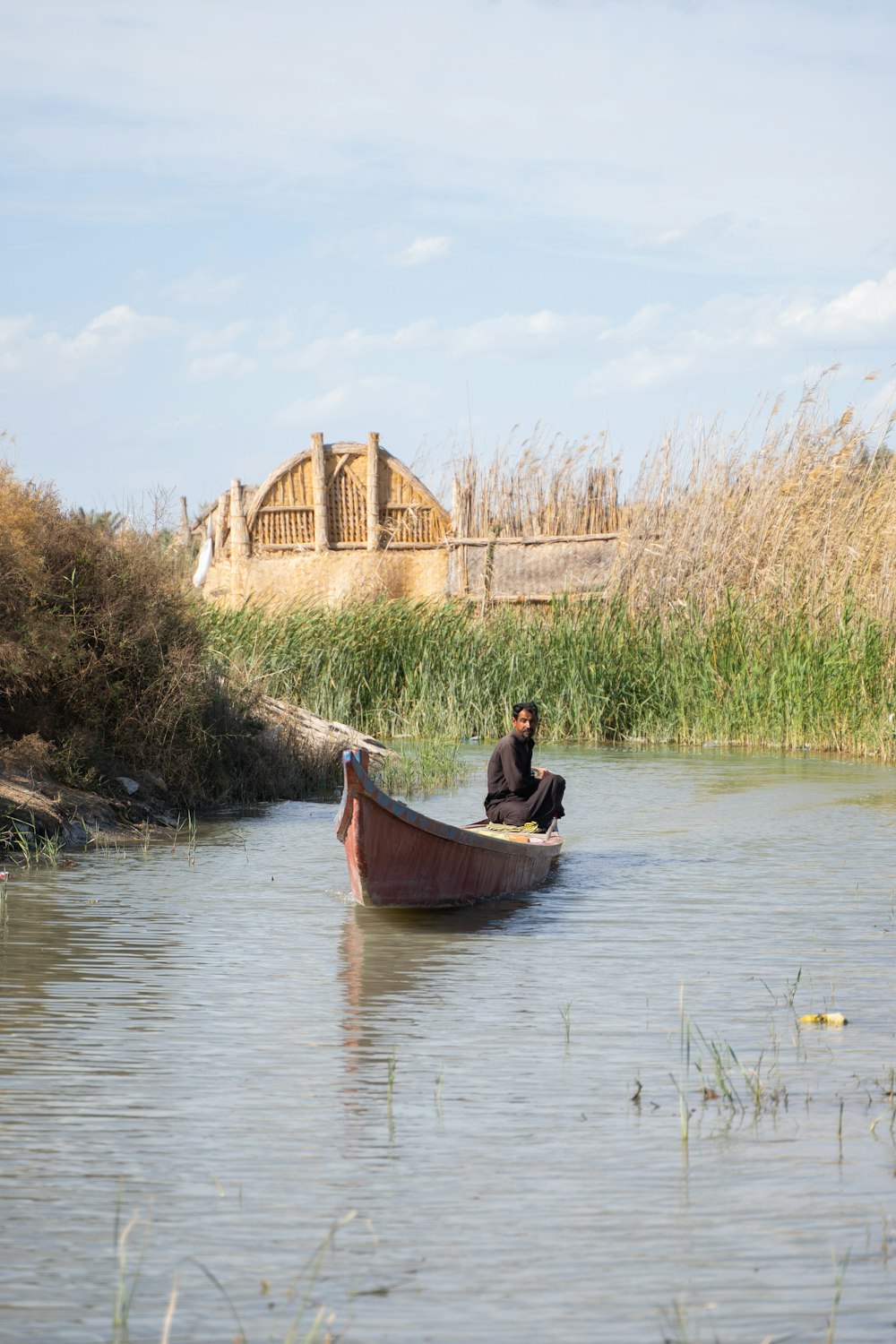a man sitting in a boat on a river