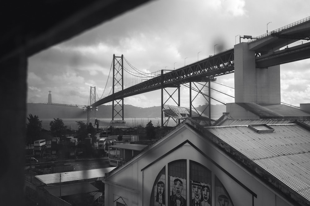 a black and white photo of a bridge over a city