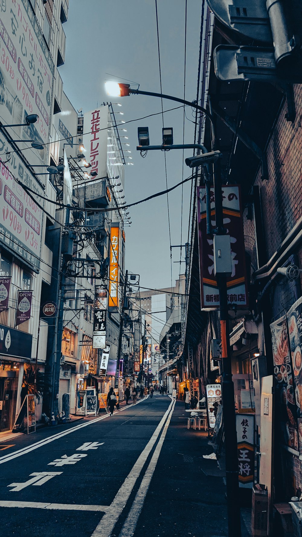 a city street lined with tall buildings and signs