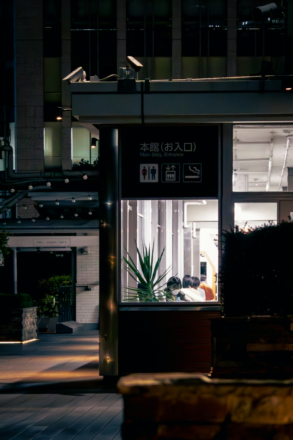 a person sitting on a bench in front of a building