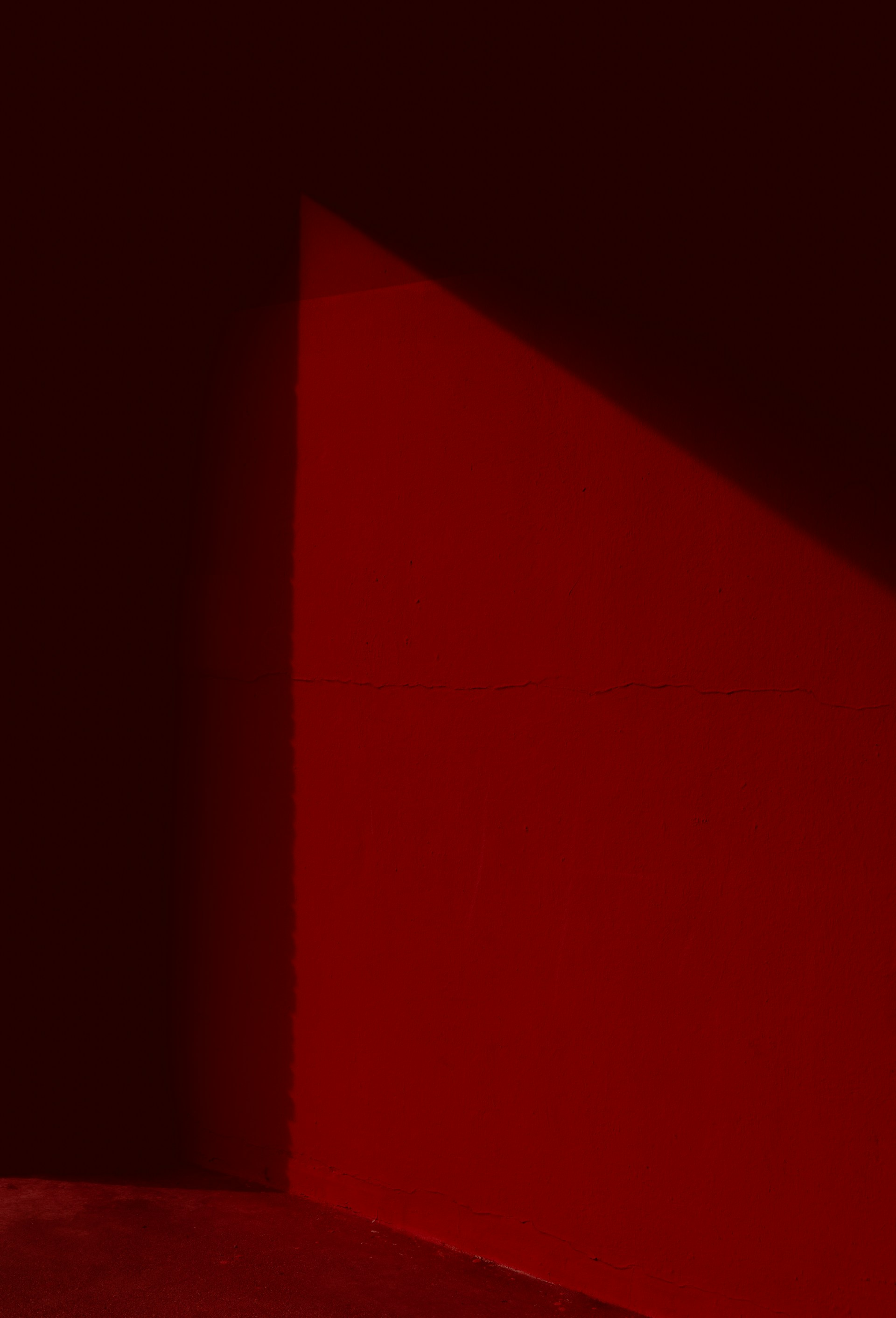 a person sitting on a bench in a dark room