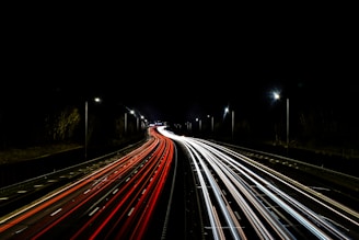 a long exposure photo of a highway at night