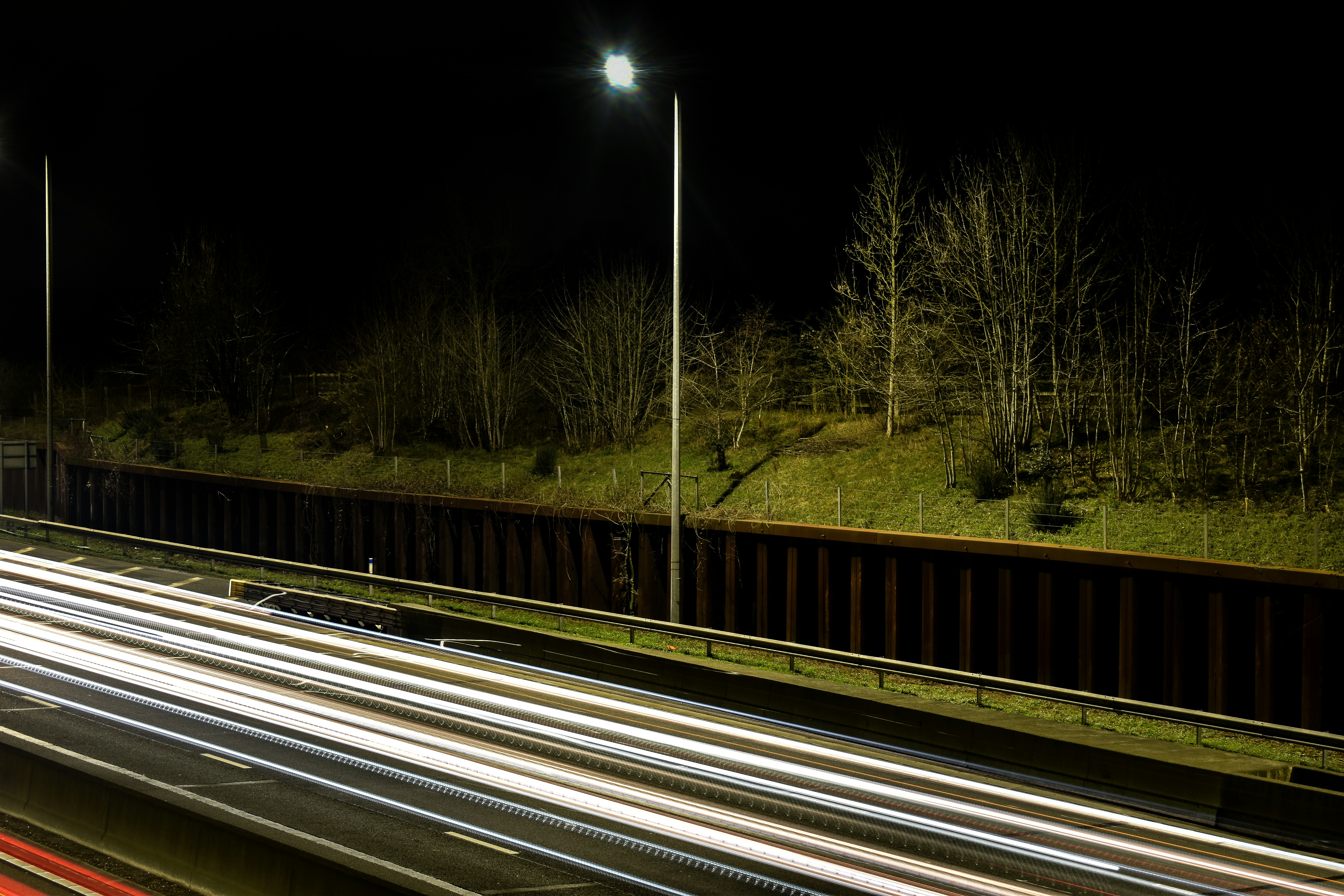 a highway at night with light streaks on the road