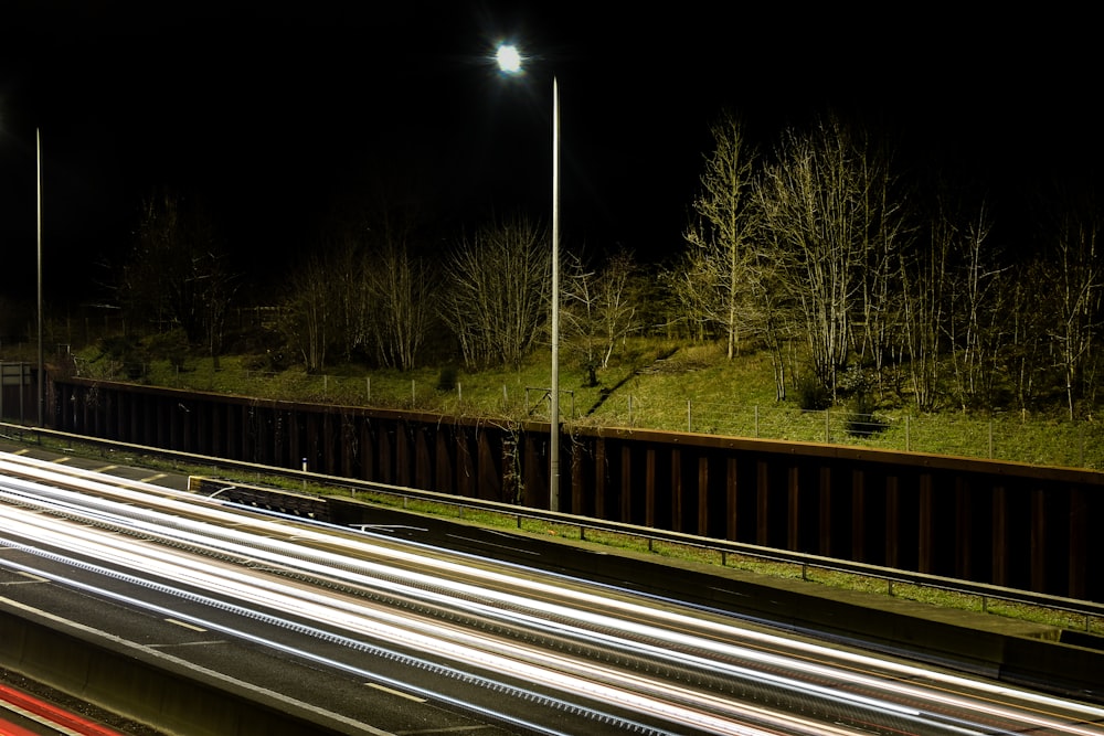 a highway at night with light streaks on the road