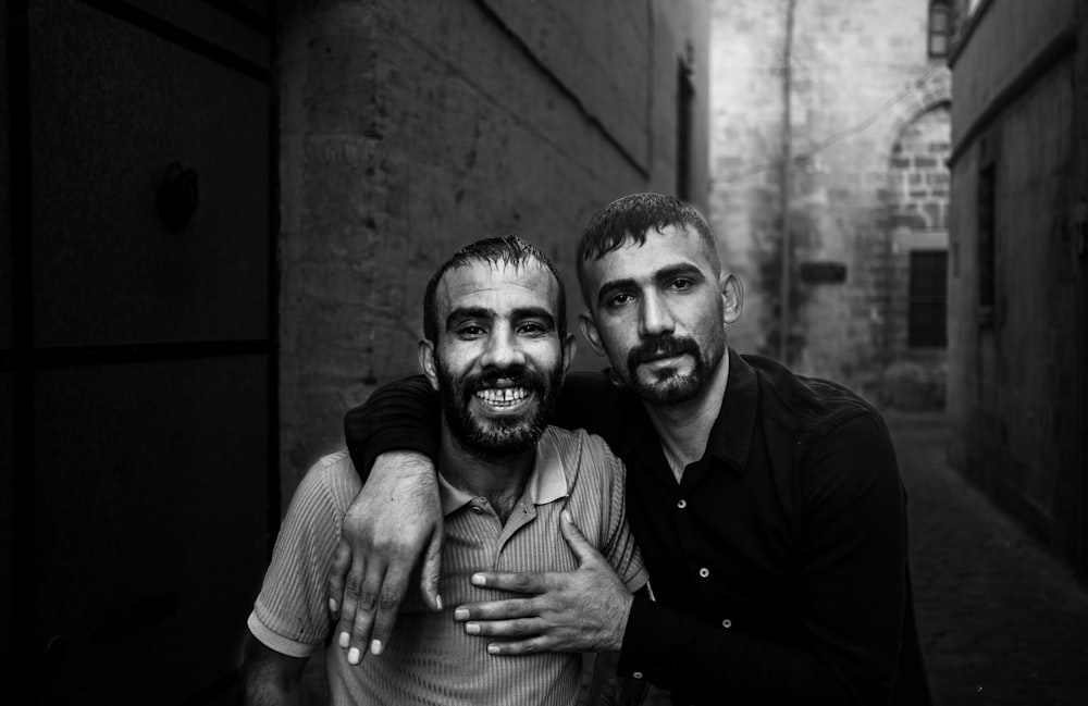 a couple of men standing next to each other