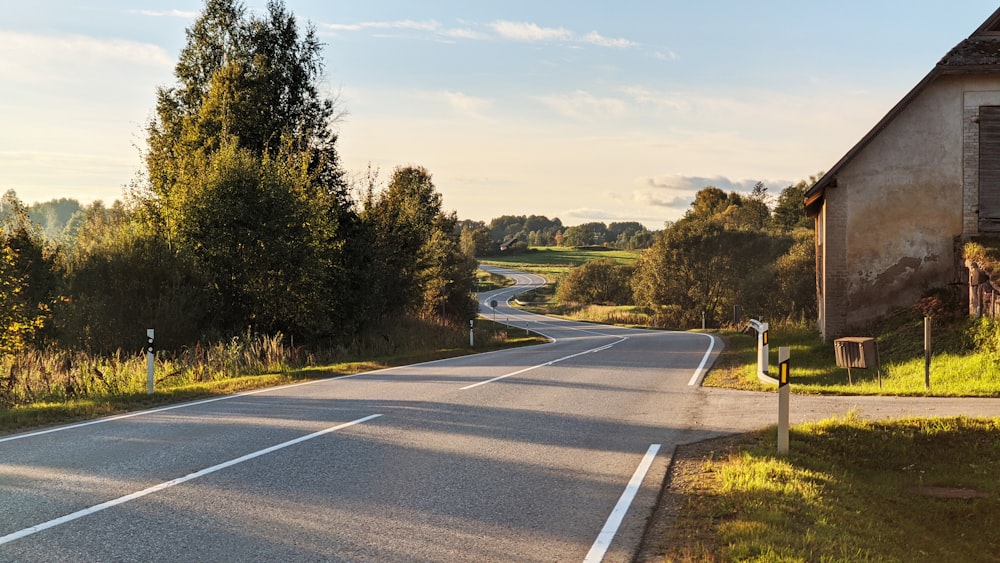 an empty road in the middle of a rural area