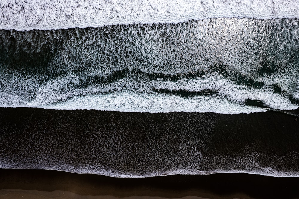 an aerial view of the ocean with waves