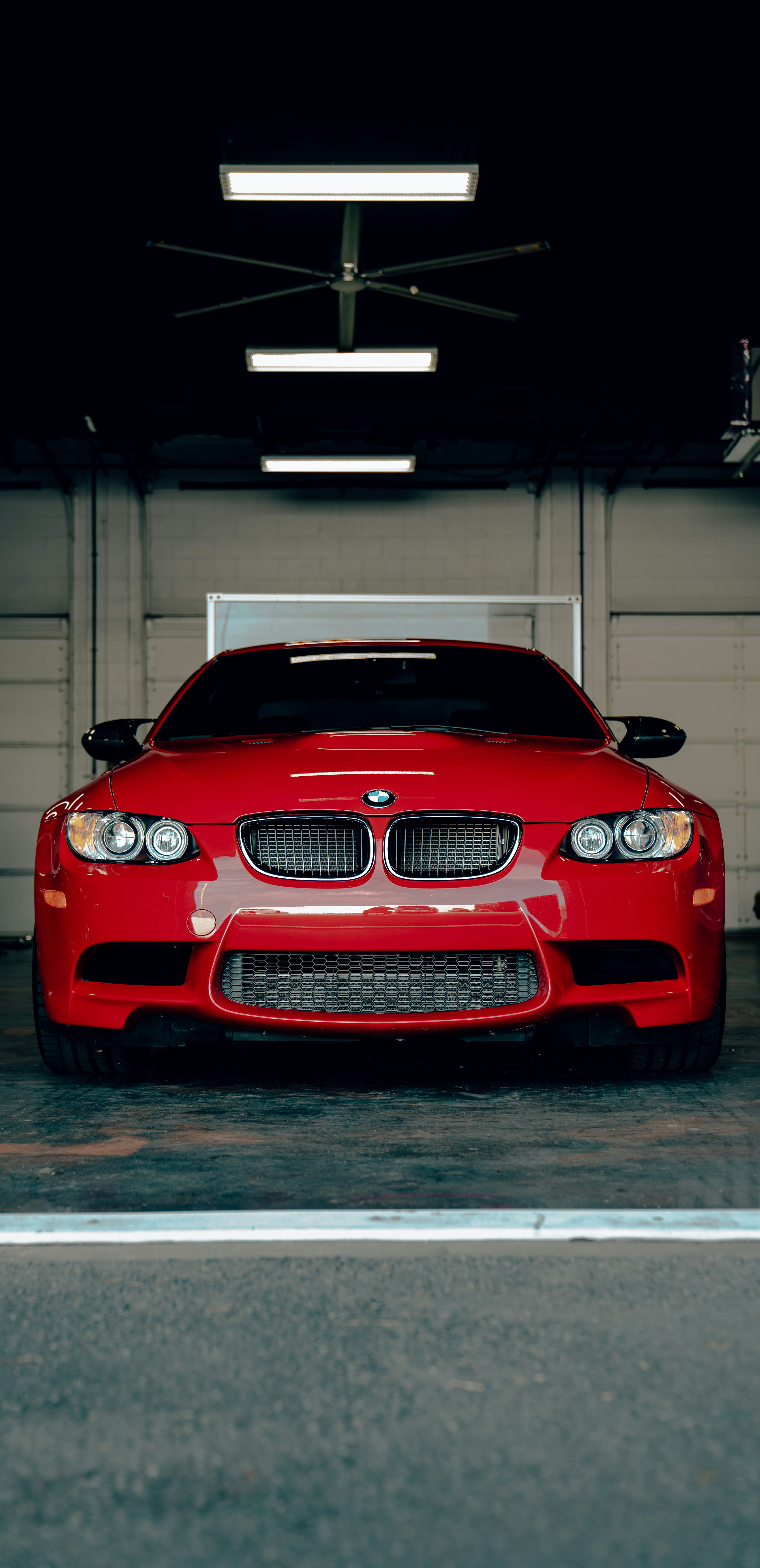 a red car is parked in a garage