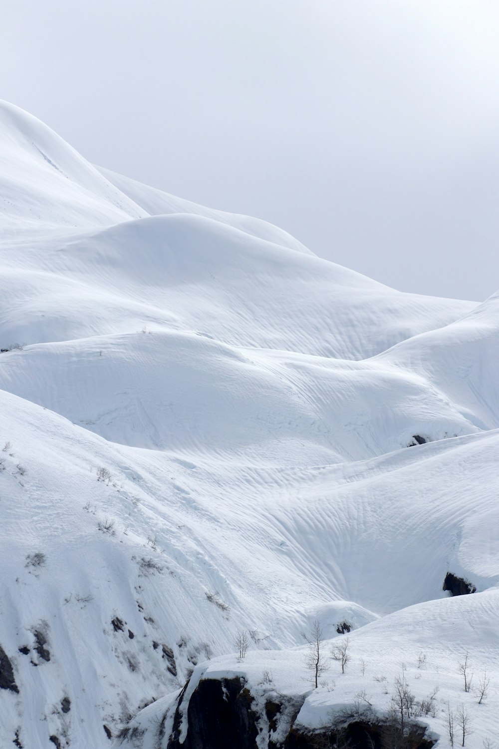 a man riding skis down a snow covered slope