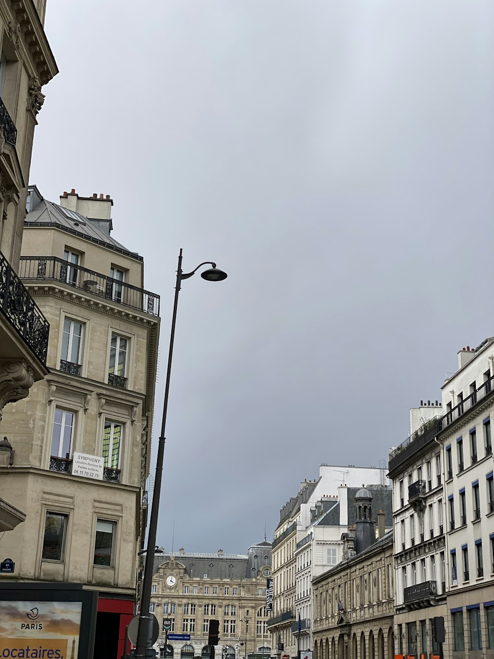 a city street with buildings and a street light