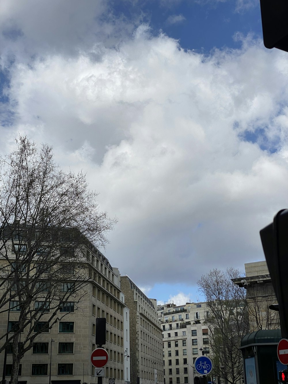 a cloudy sky over a city street filled with traffic