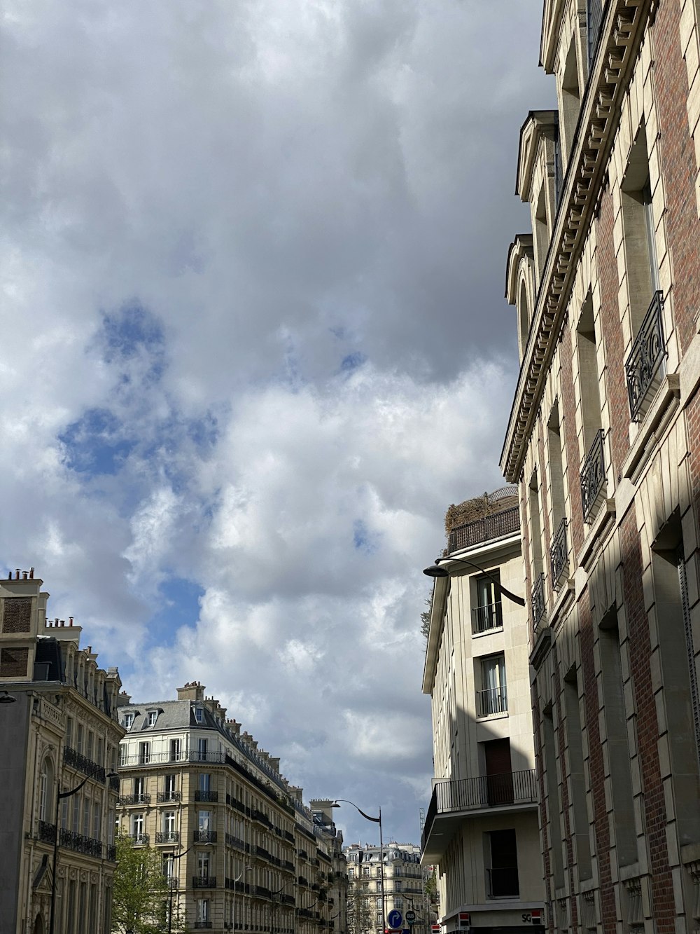 a city street with buildings and a clock tower in the distance