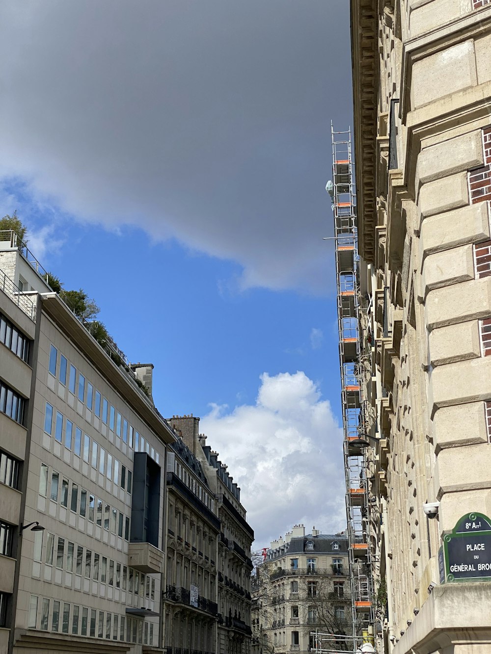 a city street with buildings and scaffolding in the background