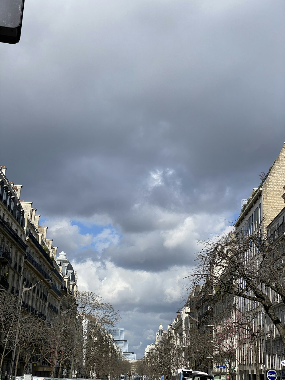 a city street with a cloudy sky in the background