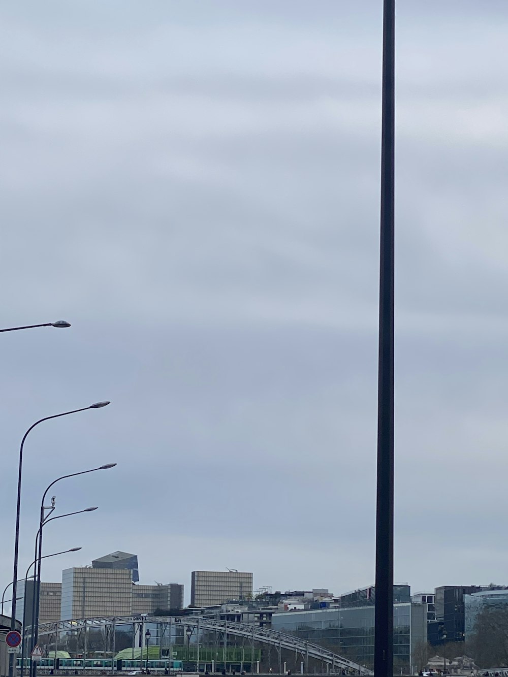 a traffic light on a street with a city in the background