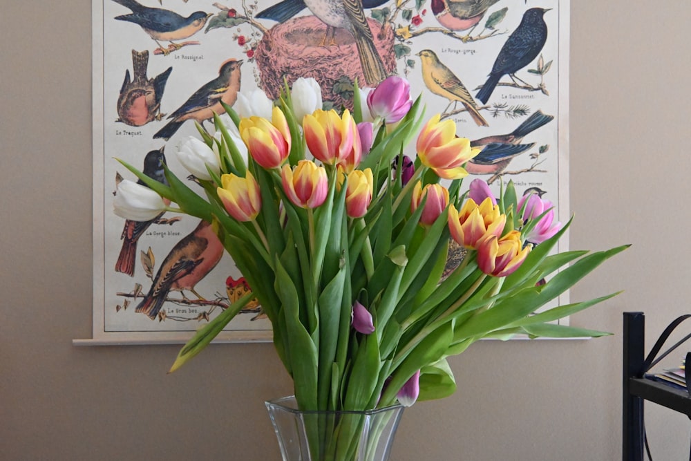 a vase filled with lots of colorful flowers