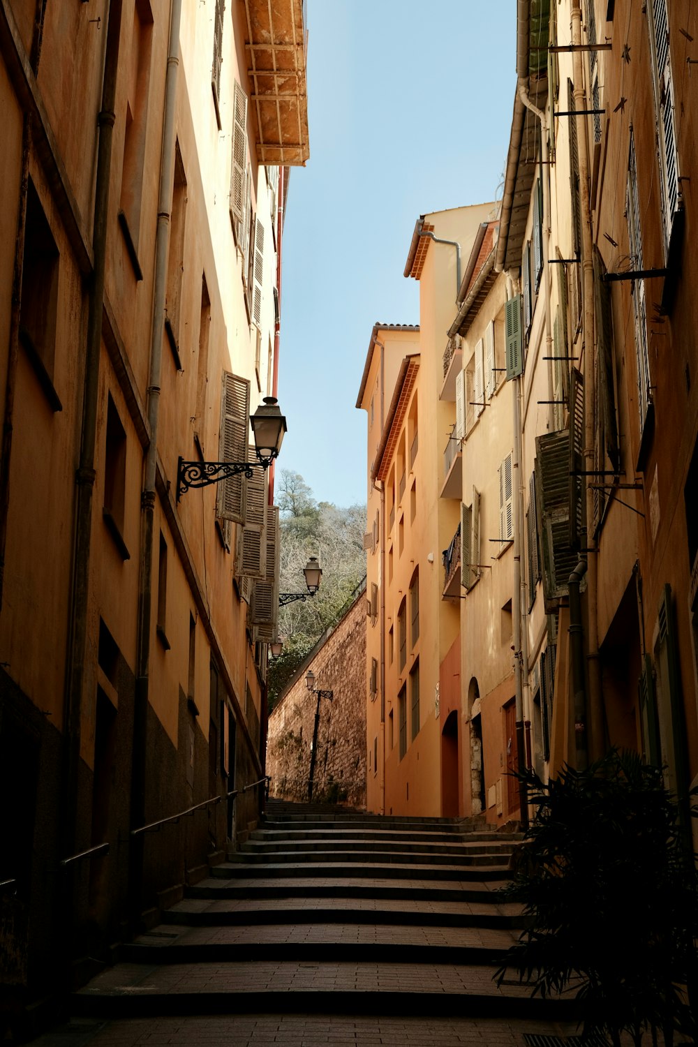 a narrow street with steps leading up to buildings