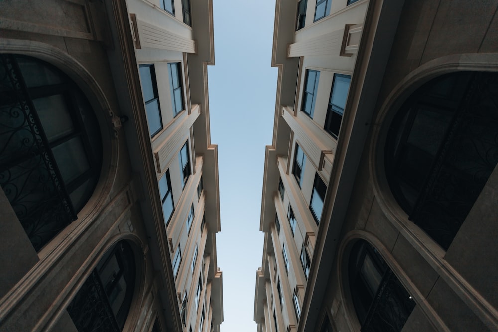 looking up at two tall buildings from the ground