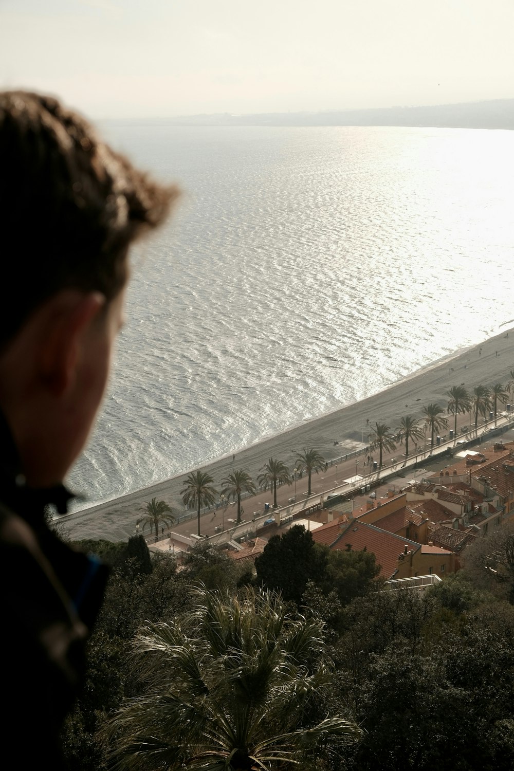 a man looking out over a beach and ocean
