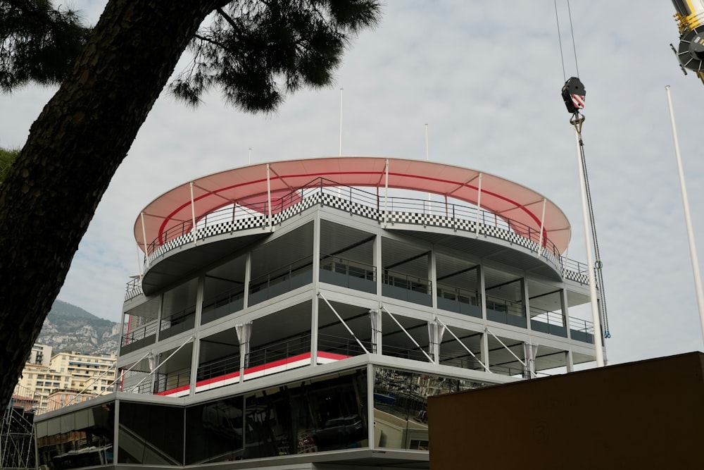 a tall building with a red roof and a balcony