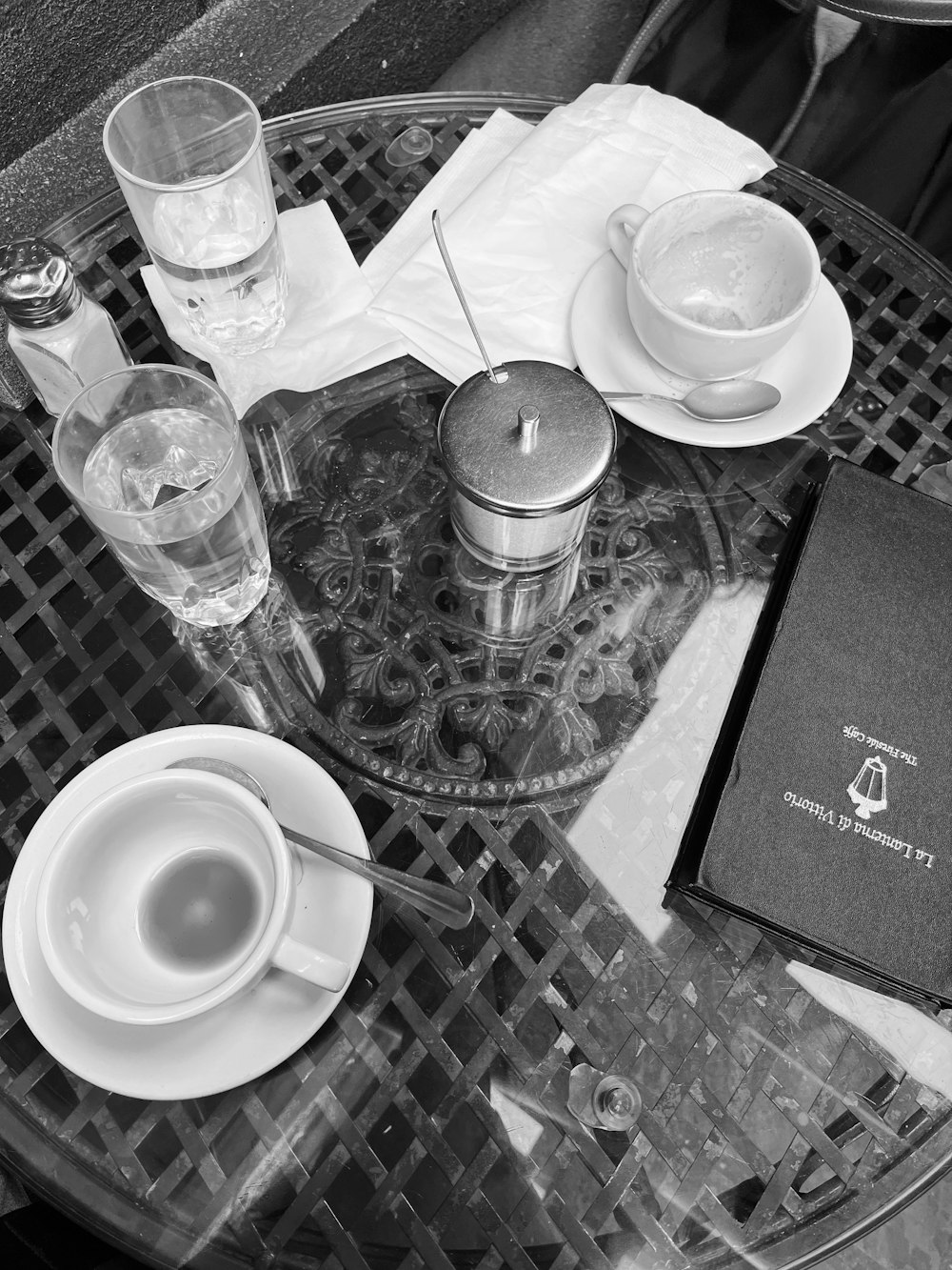 a table with a book and a cup of coffee on it