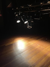 a wooden floor with lights on it in a dark room
