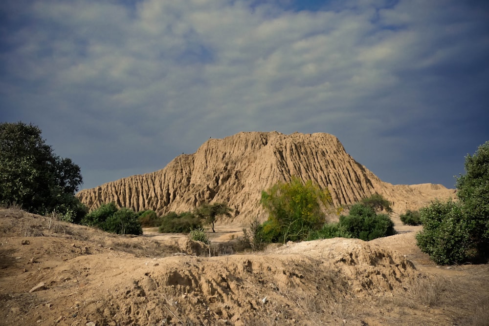 a large pile of dirt sitting on top of a dirt field