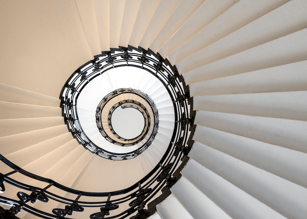 a spiral staircase with a circular light fixture