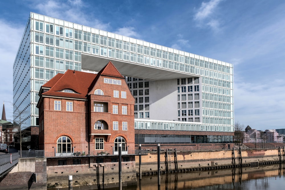 a red brick building next to a body of water