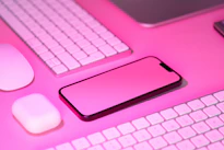 a cell phone sitting on top of a keyboard