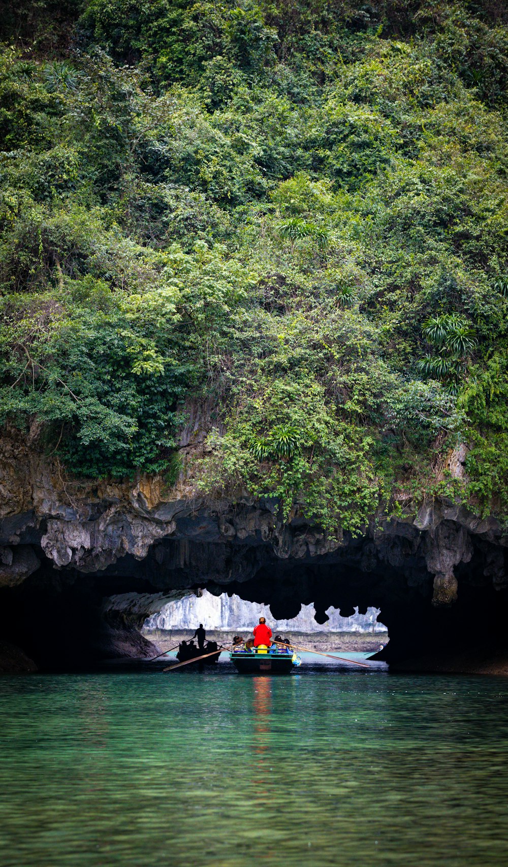 a boat in the water near a cave
