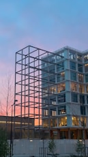 a tall building with a lot of windows next to a street